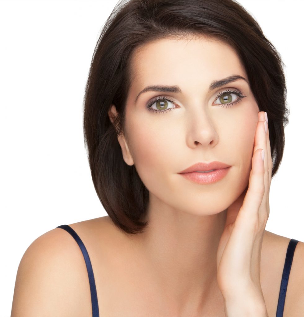 Woman with smooth skin feeling face